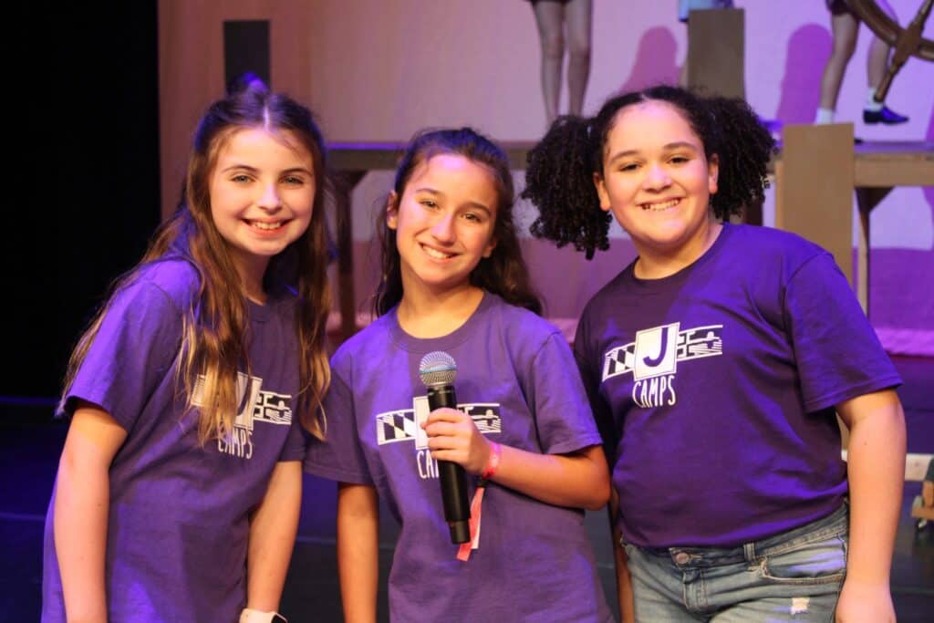 Three young ladies taking the stage with their beautiful voices.