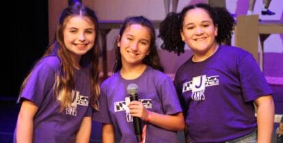 Three young ladies taking the stage with their beautiful voices.