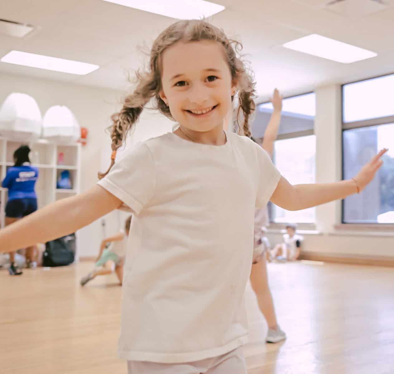 young camper smiling and dancing in studio